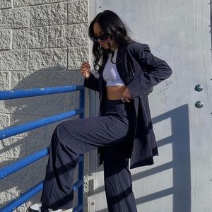 Pin stripe trousers with pleated front